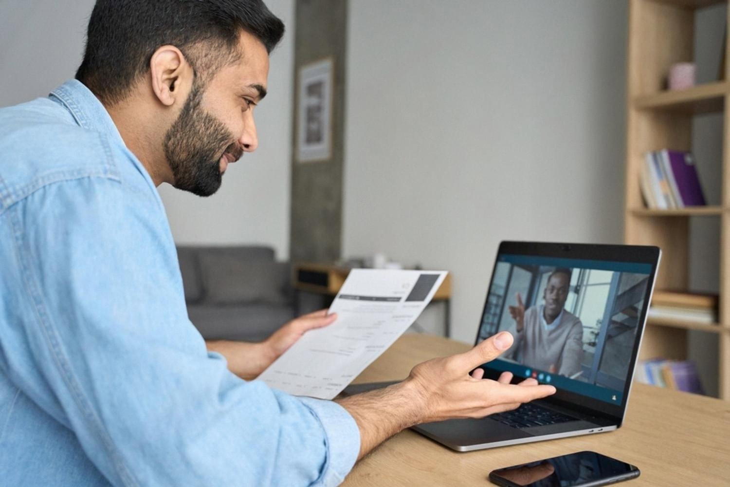 Recruiter conducting a remote video interview with a candidate while reviewing a CV